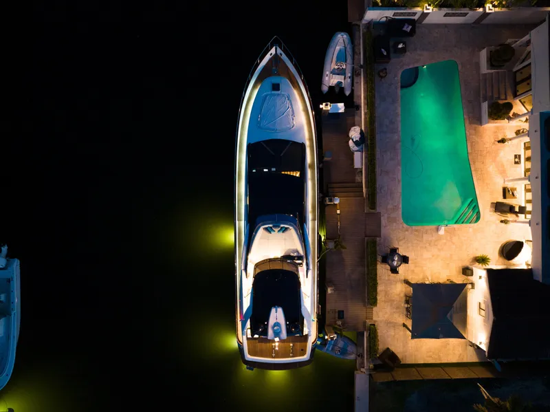 Slide: The Image of Aerial view of a 2012 Riva 75 Venere yacht docked beside a pool at night. - 16