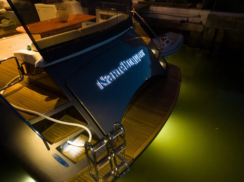 Slide: The Image of Riva 75 Venere 2012 yacht docked at night with illuminated nameplate. - 18