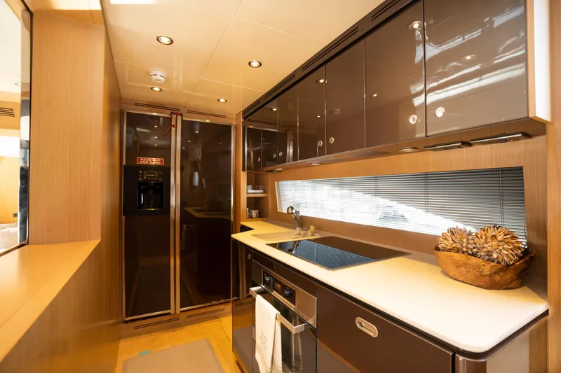 Slide: The Image of Modern kitchen interior of 2012 Riva 75 Venere yacht with sleek cabinets and appliances. - 28