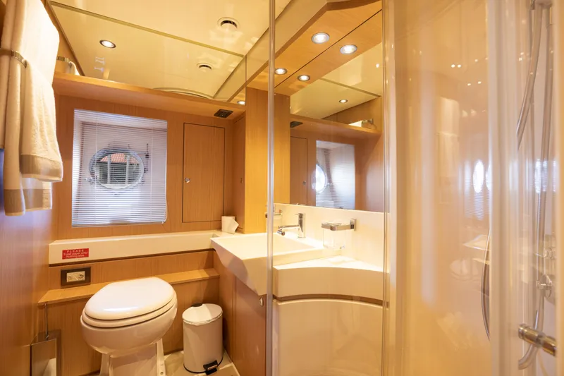Slide: The Image of Luxurious bathroom on a 2012 Riva 75 Venere yacht with modern fixtures and wooden accents. - 30