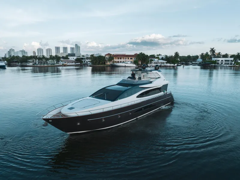 Slide: The Image of 2012 Riva 75 Venere yacht cruising in a serene waterfront setting. - 5