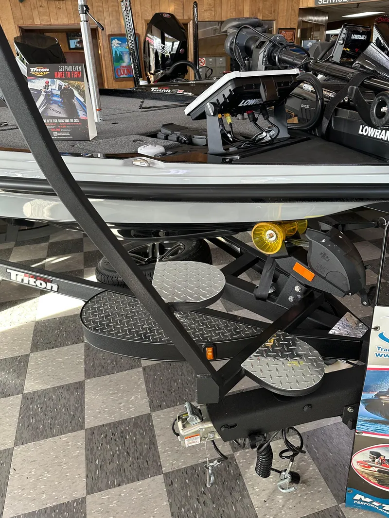 Slide: The Image of 2024 Triton 20XP Patriot boat with Lowrance equipment on display in showroom. - 10