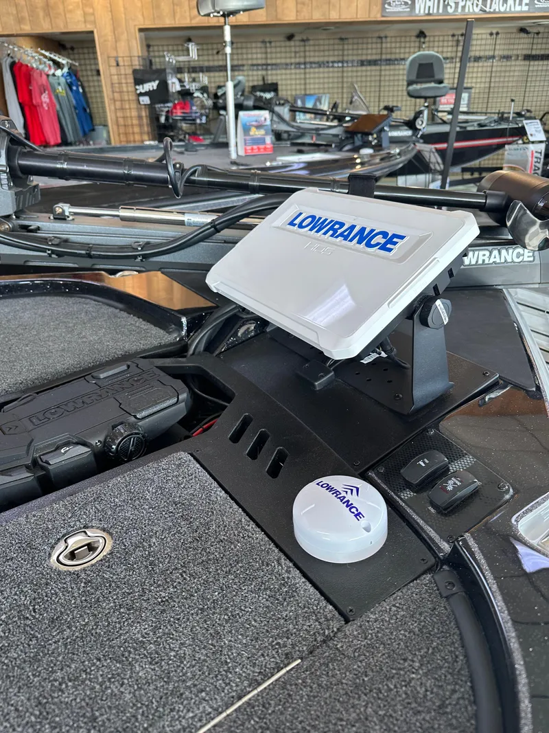 Slide: The Image of 2024 Triton 20XP Patriot boat with Lowrance navigation system in showroom. - 12