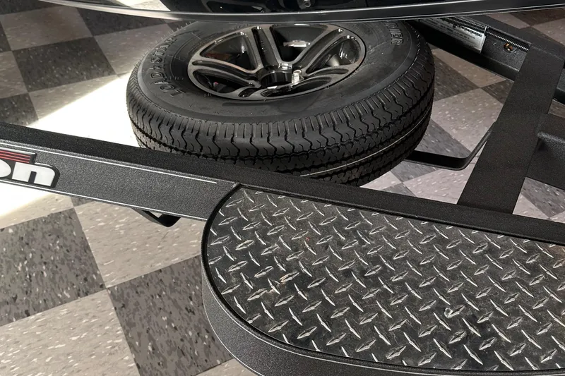 Slide: The Image of 2024 Triton 20XP Patriot trailer with spare tire and diamond plate step. - 16