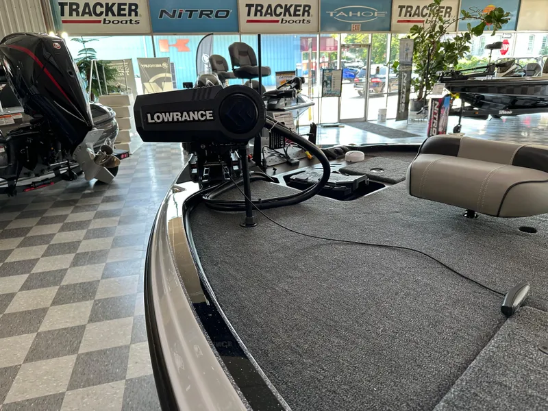 Slide: The Image of 2024 Triton 20XP Patriot boat with Lowrance equipment in showroom. - 3