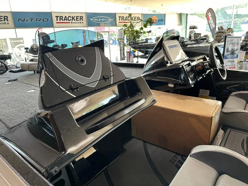 Slide: The Image of 2024 Triton 20XP Patriot boat interior at a dealership showroom. - 6