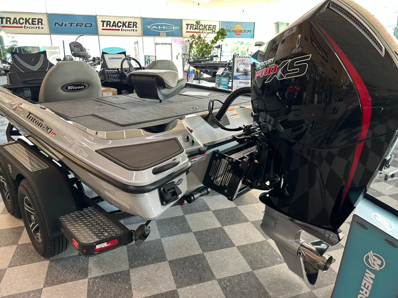 Slide: The Image of 2024 Triton 20XP Patriot boat with Mercury Pro XS engine in showroom. - 7