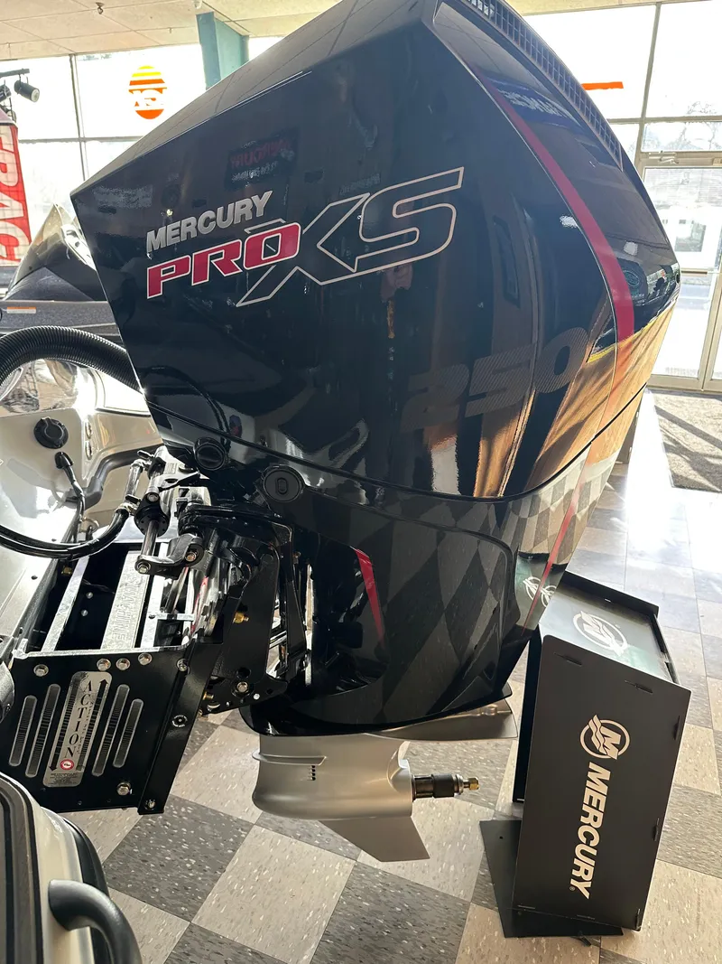 Slide: The Image of 2024 Triton 20XP Patriot with Mercury Pro XS outboard motor in showroom. - 9