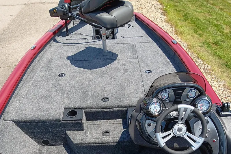 Slide: The Image of 2024 Tracker Pro Team 190 TX boat interior with steering console and seating. - 4