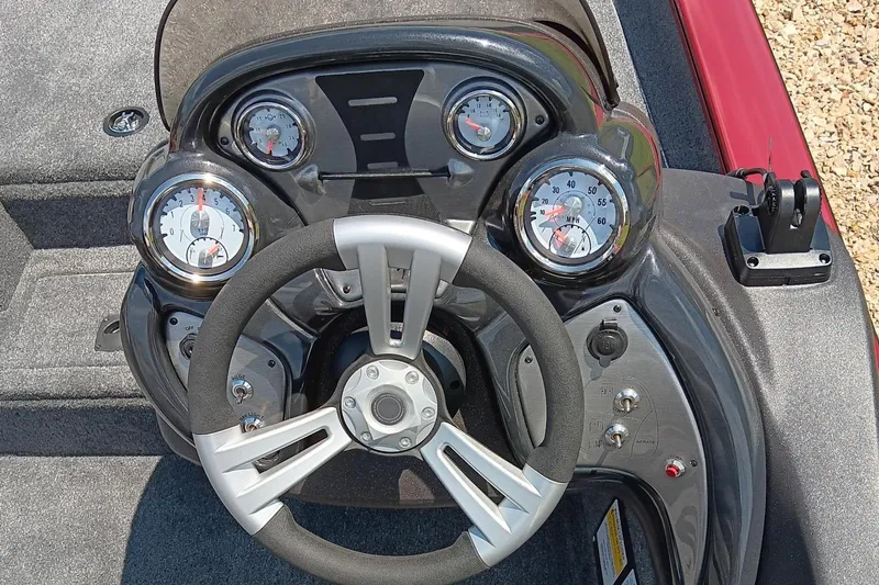 Slide: The Image of 2024 Tracker Pro Team 190 TX boat dashboard with steering wheel and gauges. - 5