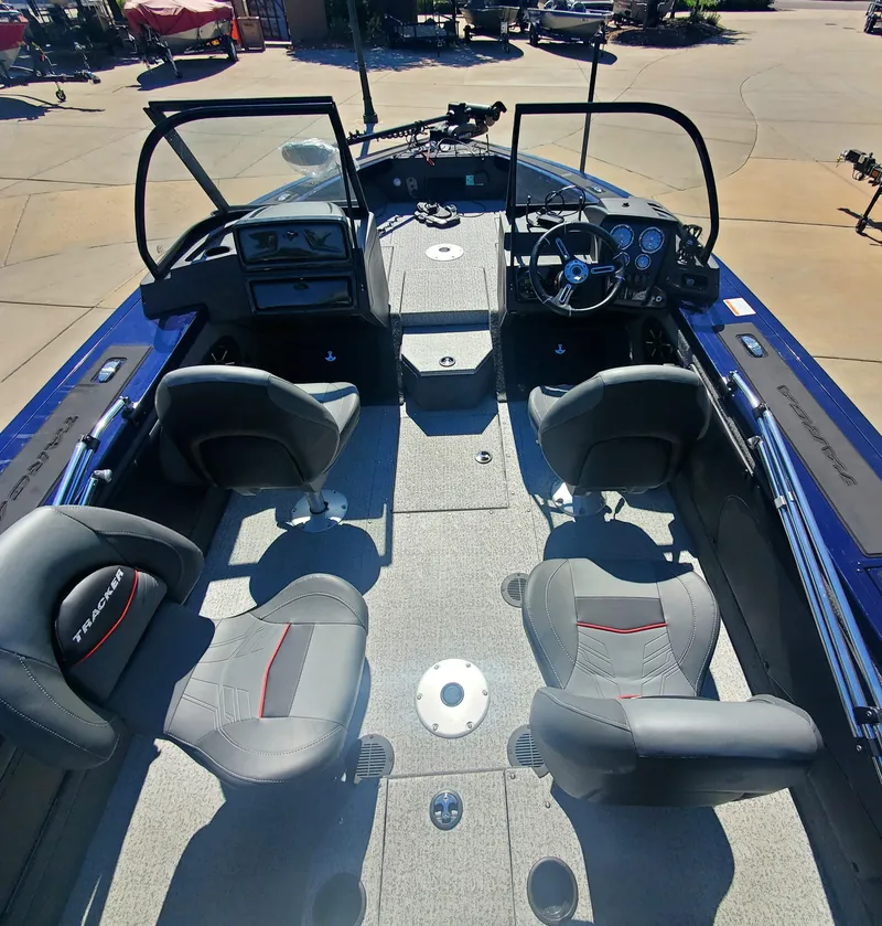 Slide: The Image of 2024 Tracker Targa V-19 WT boat interior with four seats and control panel. - 2