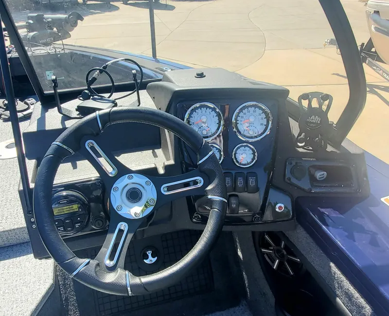 Slide: The Image of 2024 Tracker Targa V-19 WT boat dashboard with steering wheel and instrument panel. - 3