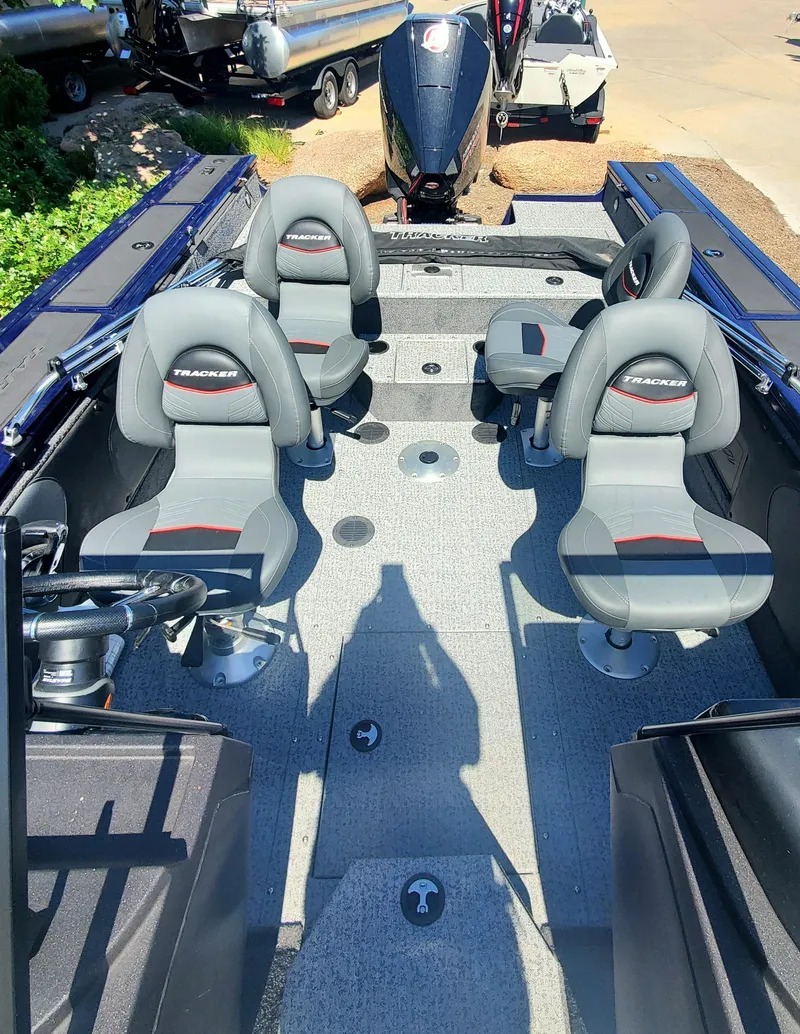 Slide: The Image of 2024 Tracker Targa V-19 WT boat interior with four seats and steering console. - 4