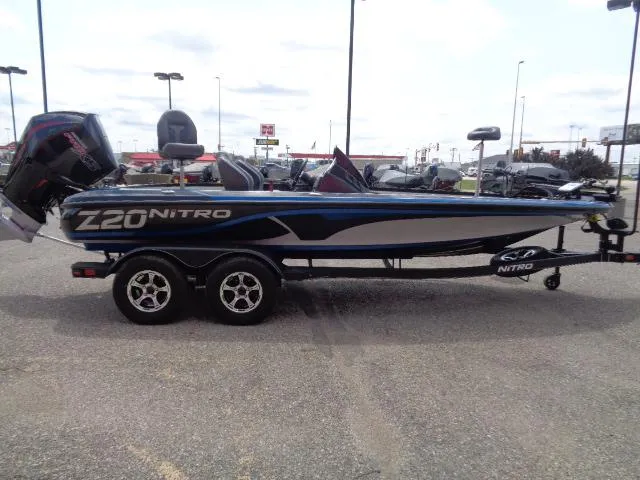 Slide: The Image of 2024 Nitro Z20 Pro fishing boat on a trailer in a parking lot. - 4
