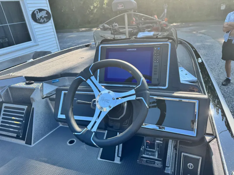 Slide: The Image of 2024 Ranger Z521R Ranger Cup Equipped boat dashboard with steering wheel and navigation system. - 4