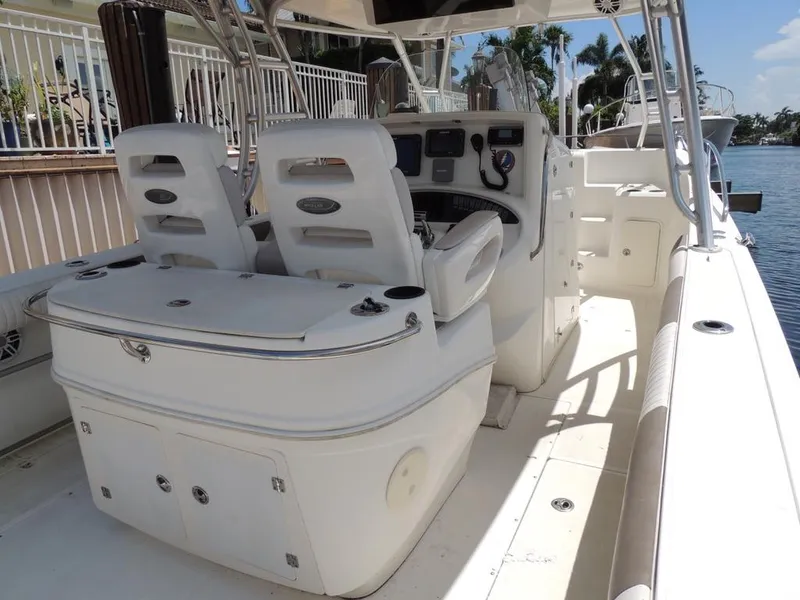 Slide: The Image of 2006 Boston Whaler 320 Outrage Cuddy Cabin interior with helm and seating. - 12