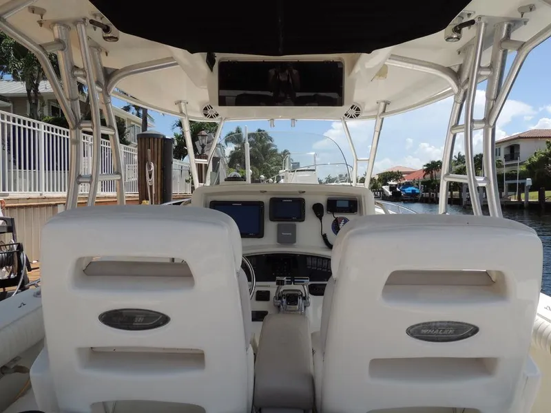 Slide: The Image of 2006 Boston Whaler 320 Outrage Cuddy Cabin helm station with dual seats. - 15