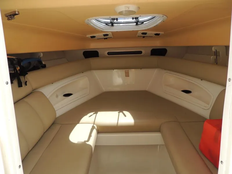 Slide: The Image of 2006 Boston Whaler 320 Outrage Cuddy Cabin interior with beige seating and overhead hatch. - 20