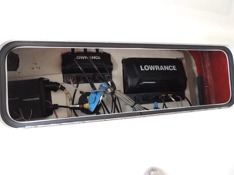 Slide: The Image of 2006 Boston Whaler 320 Outrage Cuddy Cabin electronics compartment with Lowrance equipment. - 28