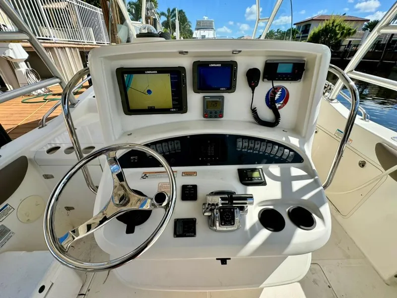 Slide: The Image of 2006 Boston Whaler 320 Outrage Cuddy Cabin helm with navigation equipment and controls. - 8