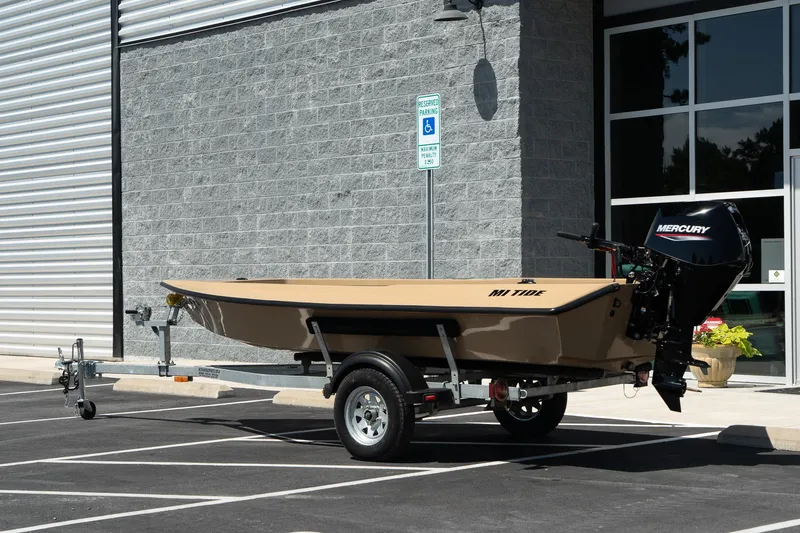 The Image of 2024 Mi Tide V1408 boat on trailer in parking lot. - 1