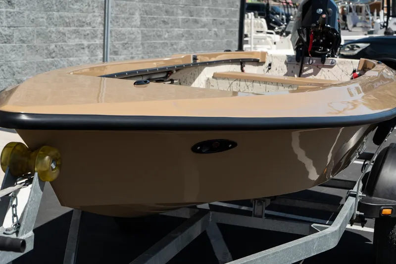 Slide: The Image of 2024 Mi Tide V1408 boat on trailer, beige hull, outdoor display. - 11