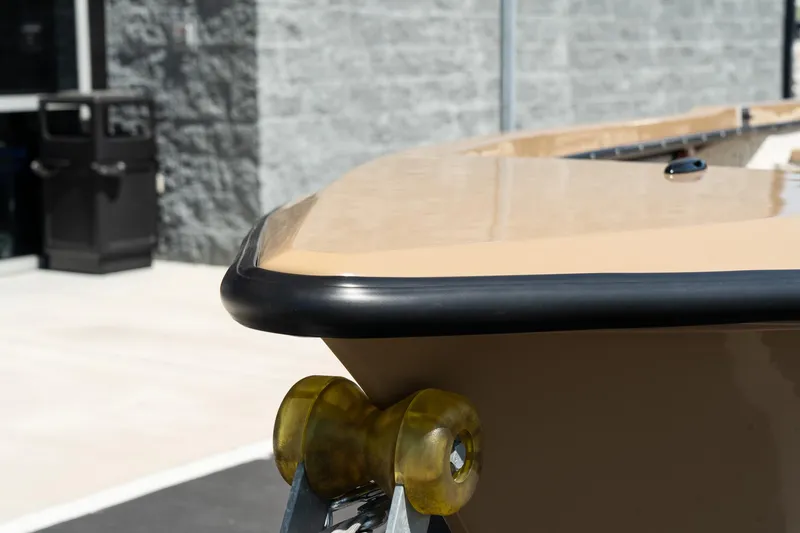 Slide: The Image of Bow of Mi Tide V1408 boat, 2024 model, on trailer near building. - 12