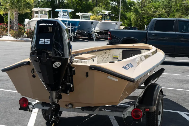 Slide: The Image of Mi Tide V1408 2024 boat with Mercury 25 outboard motor on trailer in parking lot. - 4