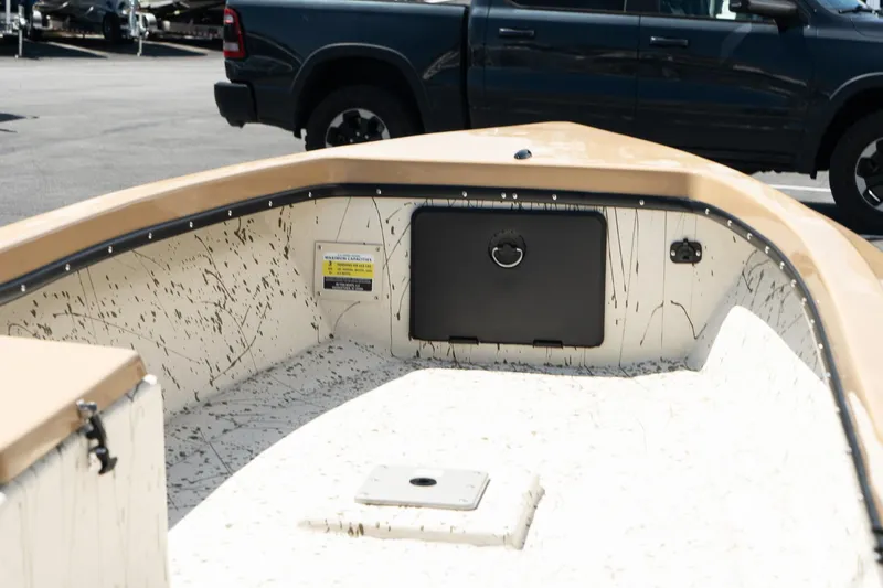 Slide: The Image of 2024 Mi Tide V1408 boat interior with storage compartment and speckled design. - 9