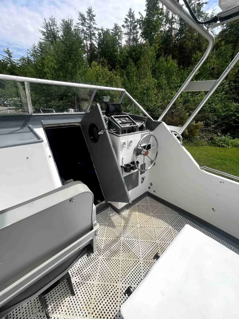 Slide: The Image of 1990 MTI 26-Foot US NAVY Personnel Boat cockpit with steering wheel and control panel. - 23