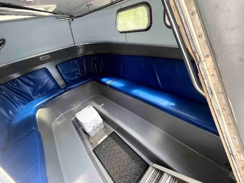 Slide: The Image of Interior of a 1990 MTI 26-Foot US NAVY Personnel Boat with blue seating. - 25