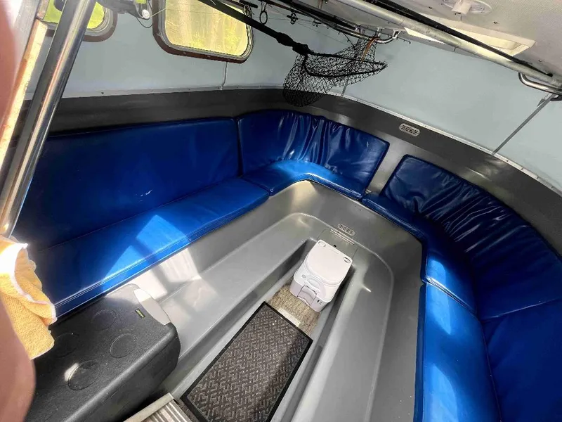 Slide: The Image of Interior of a 1990 MTI 26-Foot US NAVY Personnel Boat with blue seating. - 26