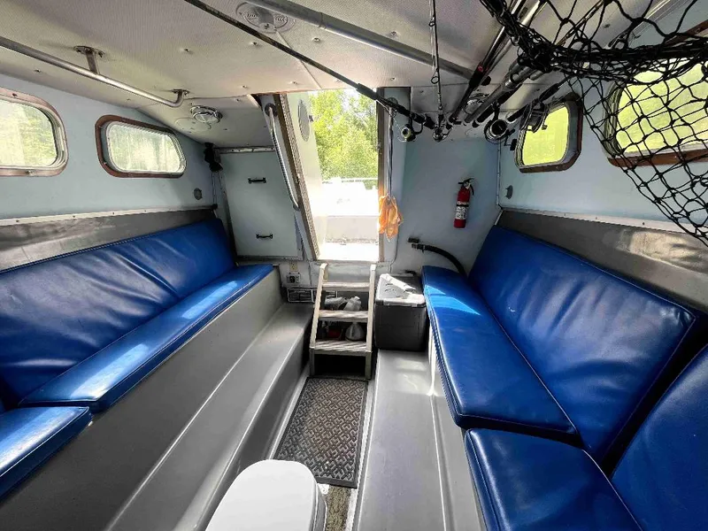 Slide: The Image of Interior of a 1990 MTI 26-Foot US NAVY Personnel Boat with blue seating. - 27