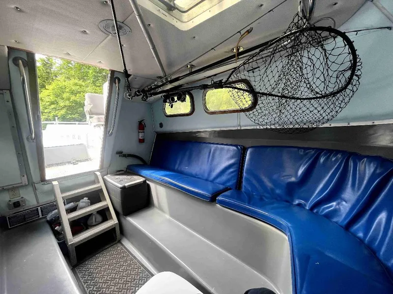 Slide: The Image of Interior of a 1990 MTI 26-Foot US NAVY Personnel Boat with blue seating. - 28