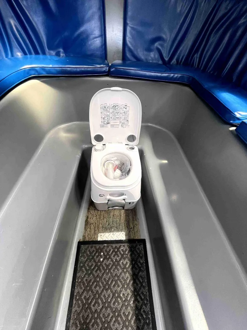Slide: The Image of Portable toilet inside 1990 MTI 26-Foot US NAVY Personnel Boat with blue seating. - 29