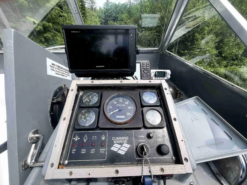 Slide: The Image of 1990 MTI 26-Foot US NAVY Personnel Boat dashboard with Cummins Marine controls and Garmin display. - 35