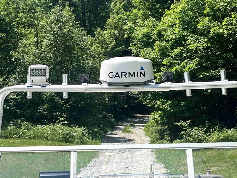 Slide: The Image of 1990 MTI 26-Foot US NAVY Personnel Boat with Garmin equipment in a forested area. - 36