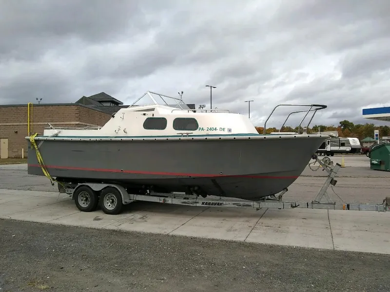 Slide: The Image of 1990 MTI 26-Foot US NAVY Personnel Boat on trailer in parking lot. - 45