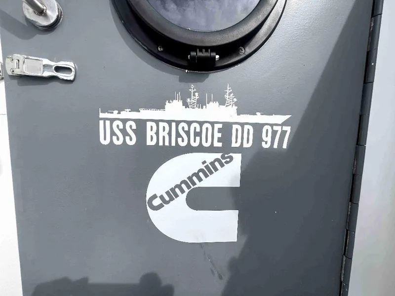 Slide: The Image of Door of 1990 MTI 26-Foot US NAVY Personnel Boat with USS Briscoe DD 977 and Cummins logo. - 49