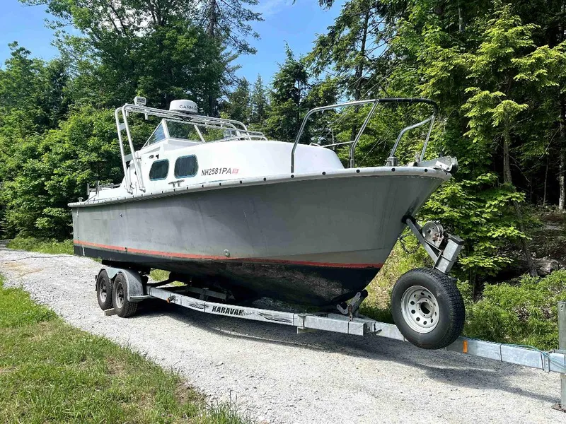 Slide: The Image of 1990 MTI 26-Foot US NAVY Personnel Boat on trailer in wooded area. - 5