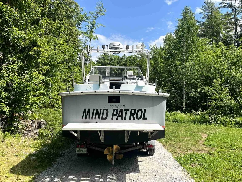 Slide: The Image of 1990 MTI 26-Foot US NAVY Personnel Boat Mind Patrol on a trailer in a wooded area. - 8