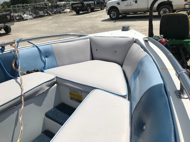 Slide: The Image of 1990 Sea Sprite 155BR boat interior with white and blue seating. - 10