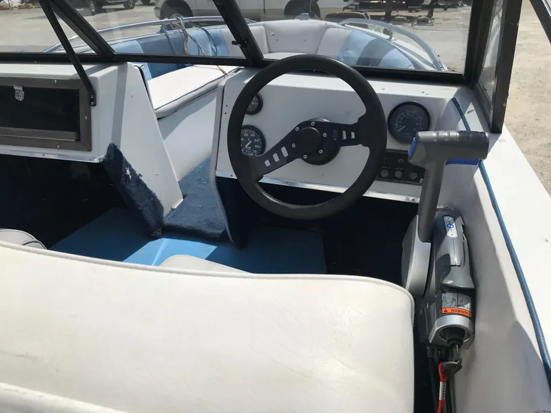 Slide: The Image of 1990 Sea Sprite 155BR boat cockpit with steering wheel and controls. - 11