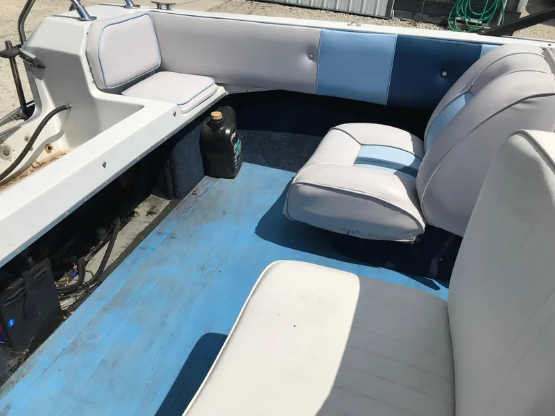 Slide: The Image of 1990 Sea Sprite 155BR boat interior with blue and white seating. - 13