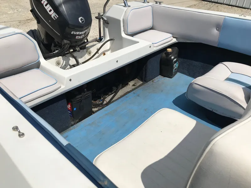 Slide: The Image of 1990 Sea Sprite 155BR boat interior with Evinrude outboard motor and seating. - 14