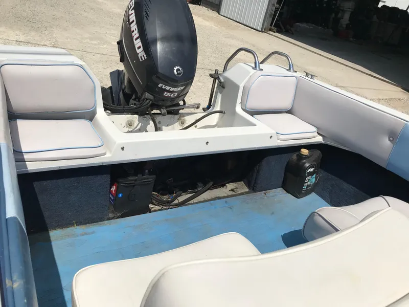 Slide: The Image of 1990 Sea Sprite 155BR boat interior with Evinrude outboard motor. - 15