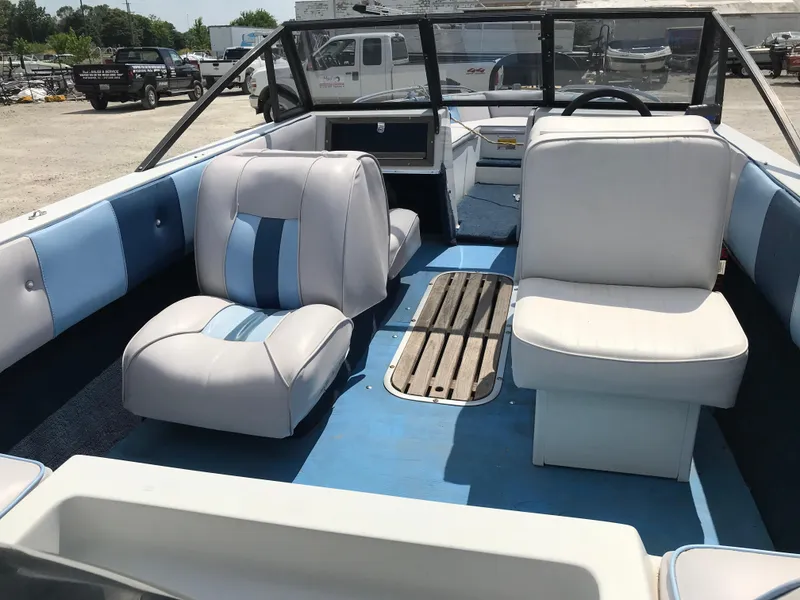 Slide: The Image of 1990 Sea Sprite 155BR boat interior with blue and white seating. - 16