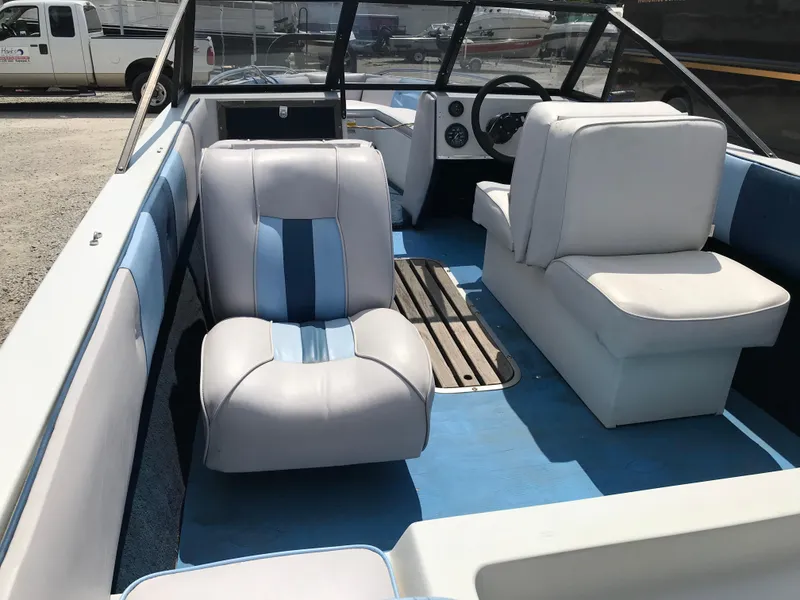 Slide: The Image of 1990 Sea Sprite 155BR boat interior with blue and white seating. - 17