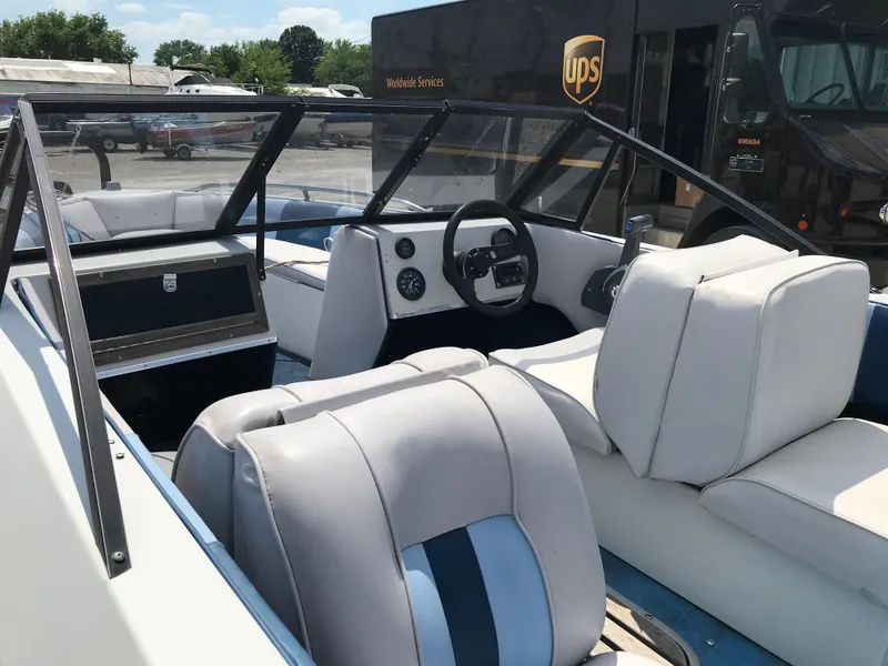 Slide: The Image of 1990 Sea Sprite 155BR boat interior with white and blue seating. - 18