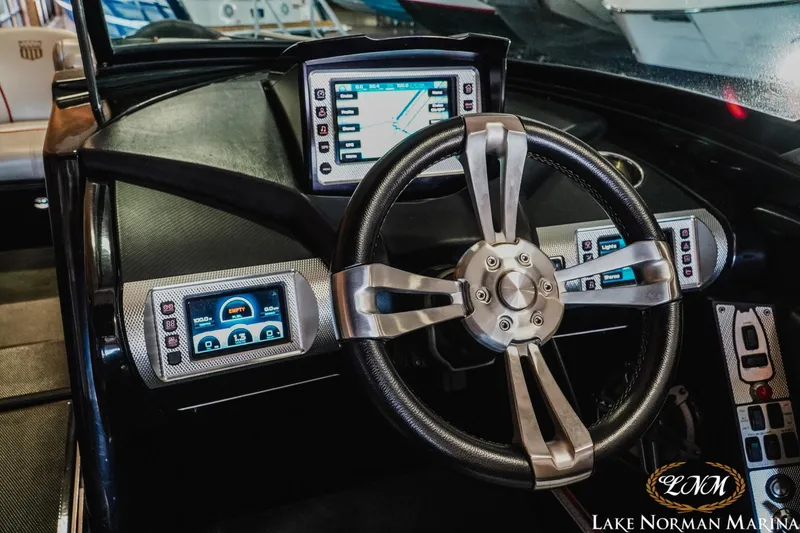 Slide: The Image of 2014 MasterCraft XStar dashboard with advanced navigation and control screens. - 13